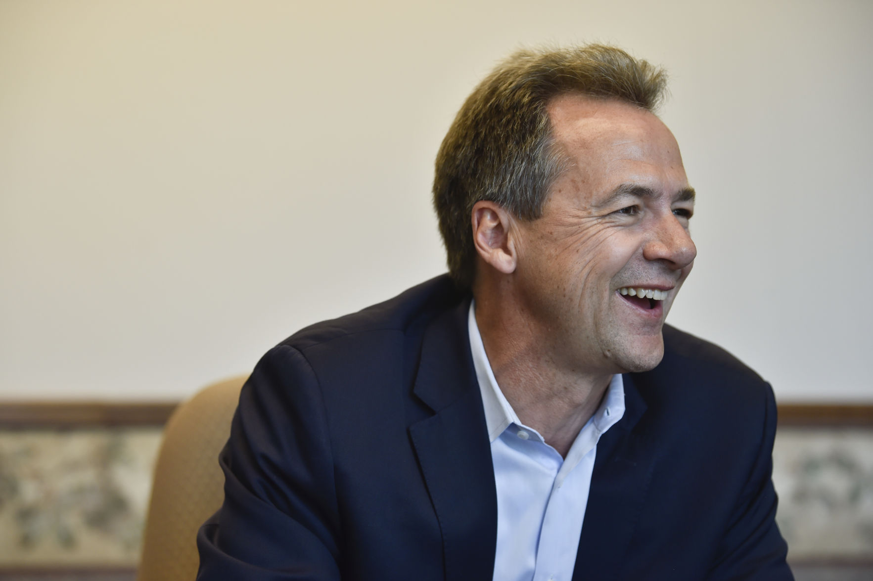 Gov. Steve Bullock talks with a reporter